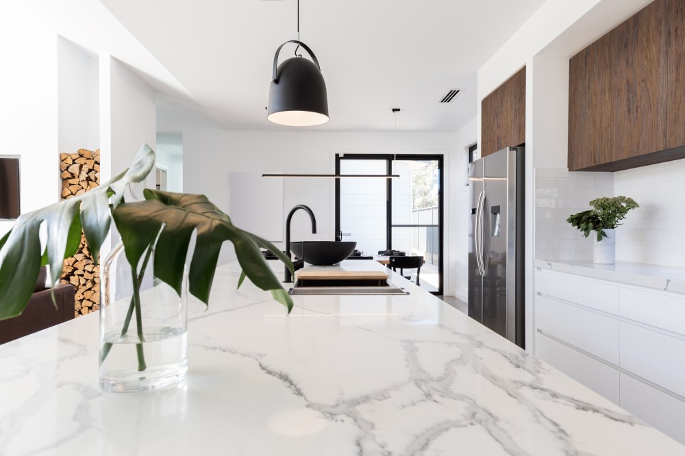 Kitchen marble bench close up with black hanging pendant